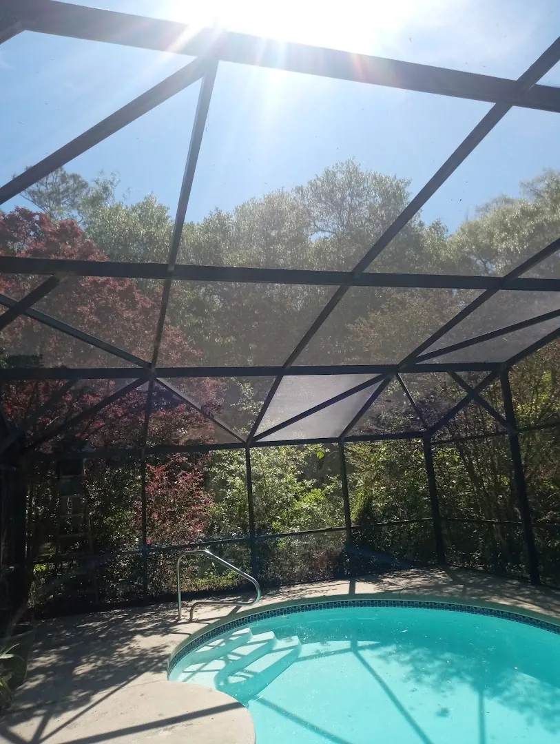 Screened enclosure overlooking a pool